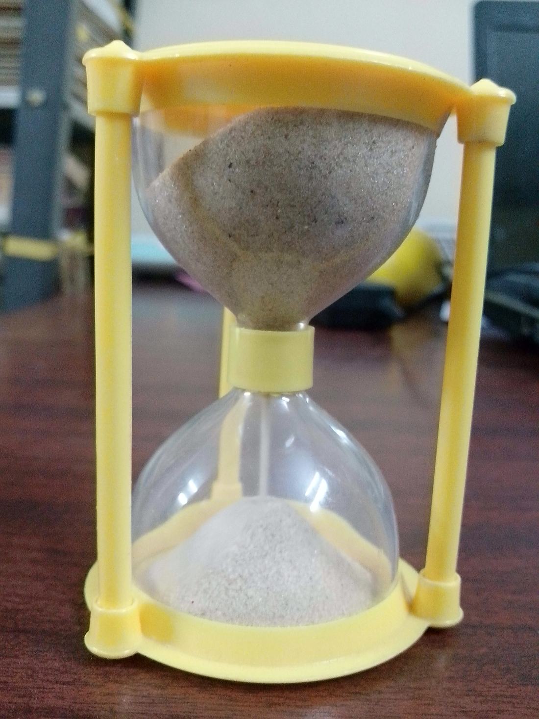 An hourglass with sand running through